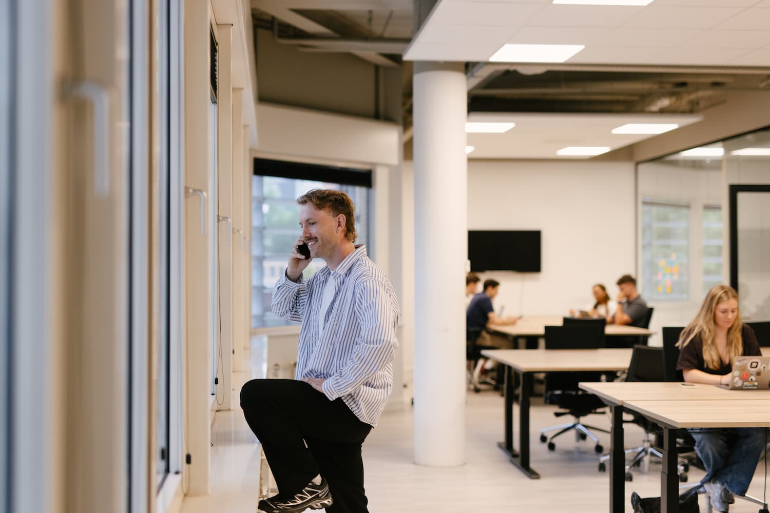 Joost calling in front of window