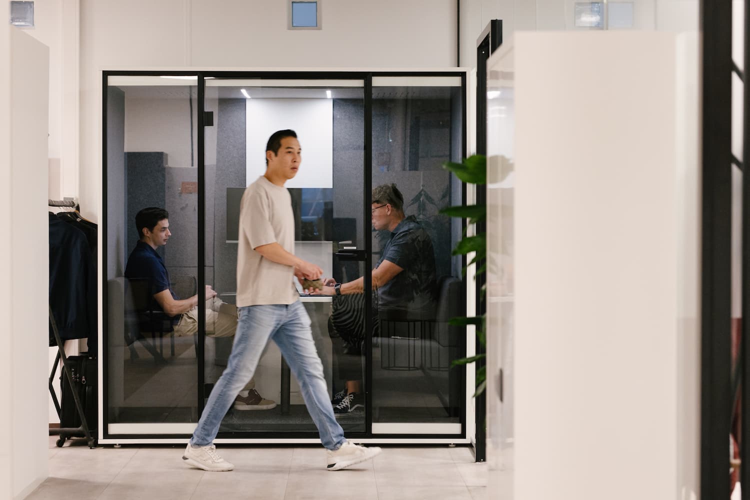 Keith walking in front of phone booth