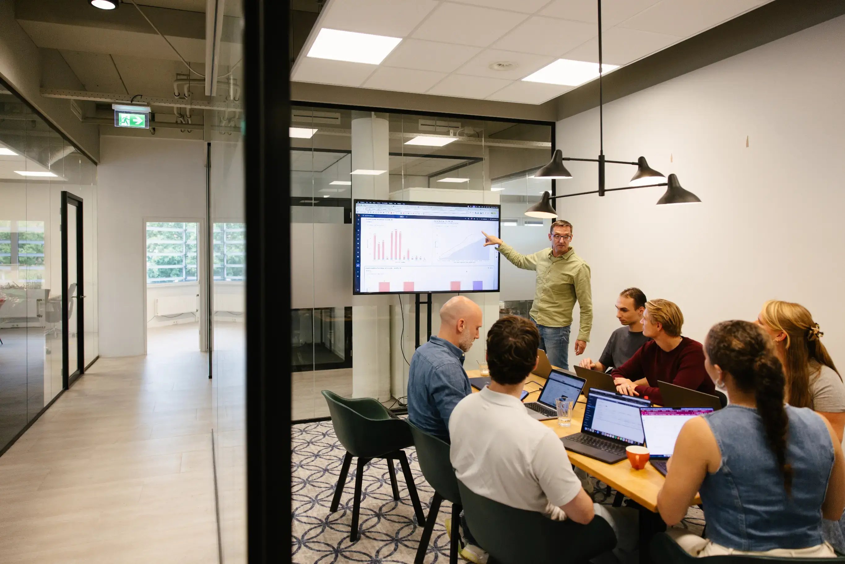 People in meeting room presenting