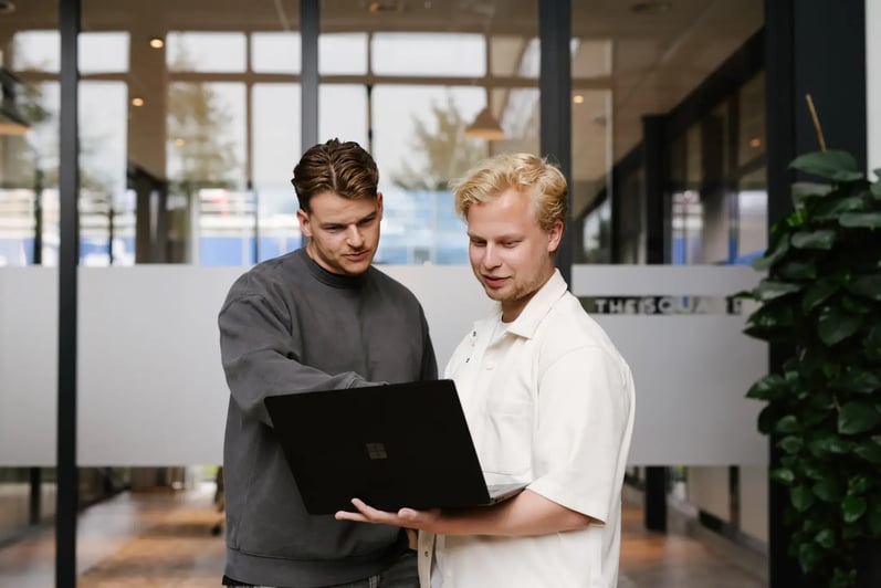 Roy and Tom in front of laptop