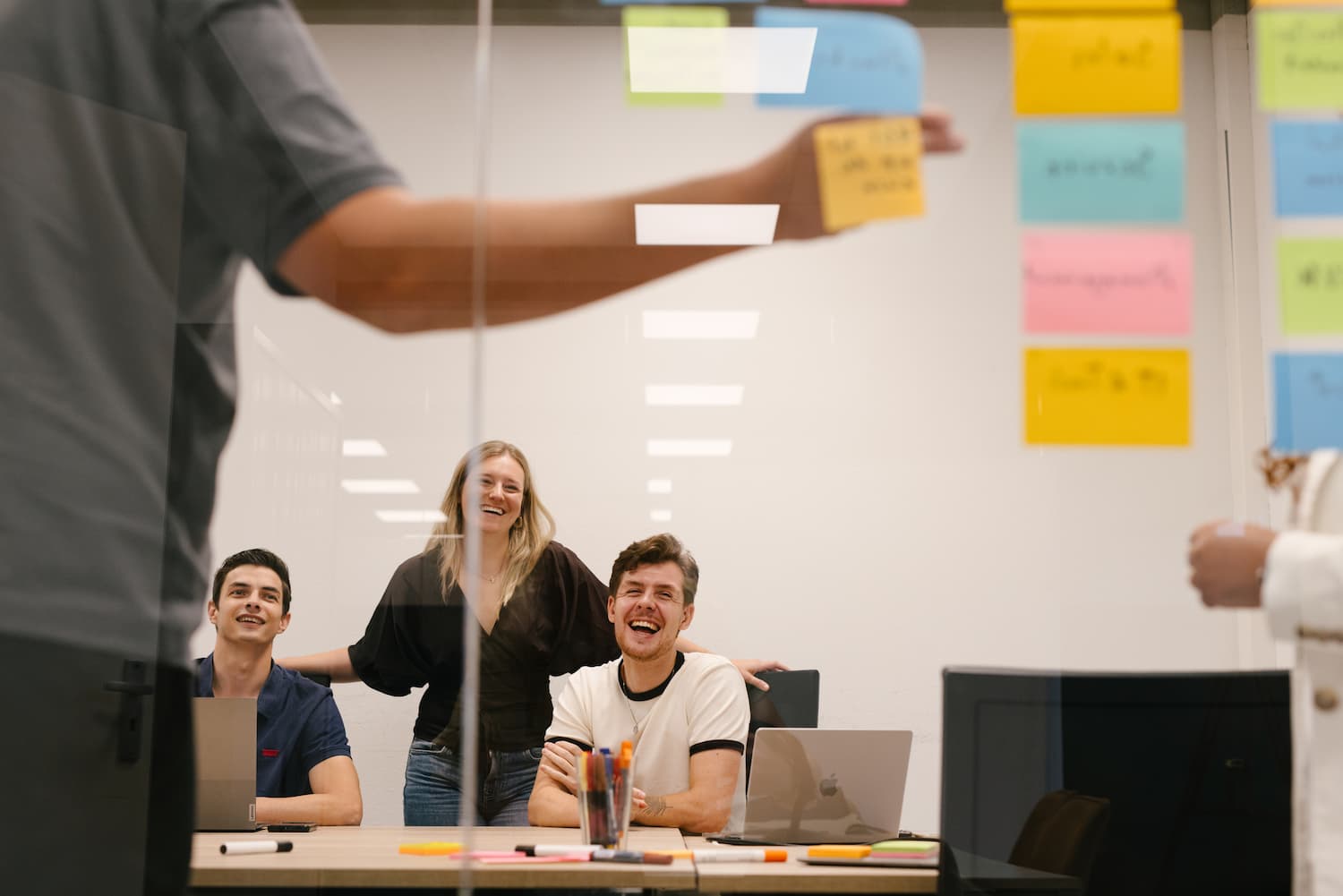 Thomas Lotta Colin looking at glass wall